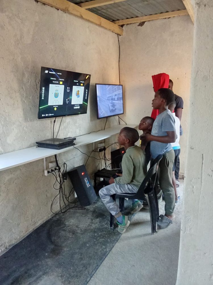 Kids playing on wall-mounted screens in a neighbourhood hub